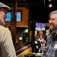 Two alums having a conversation at the event.